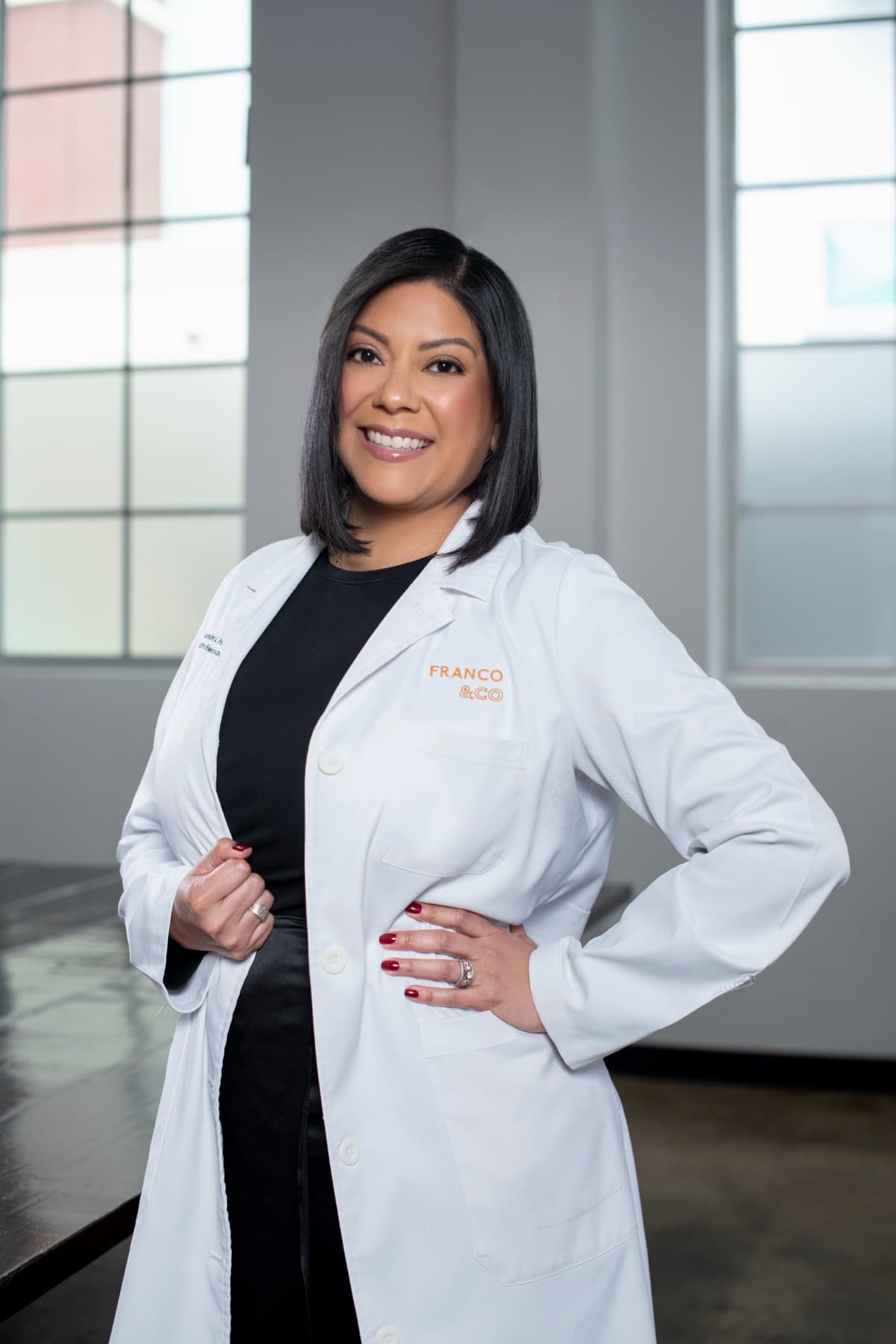 Dr. Sandra Franco, DPM, founder of FRANCO & CO, in branded clinical coat